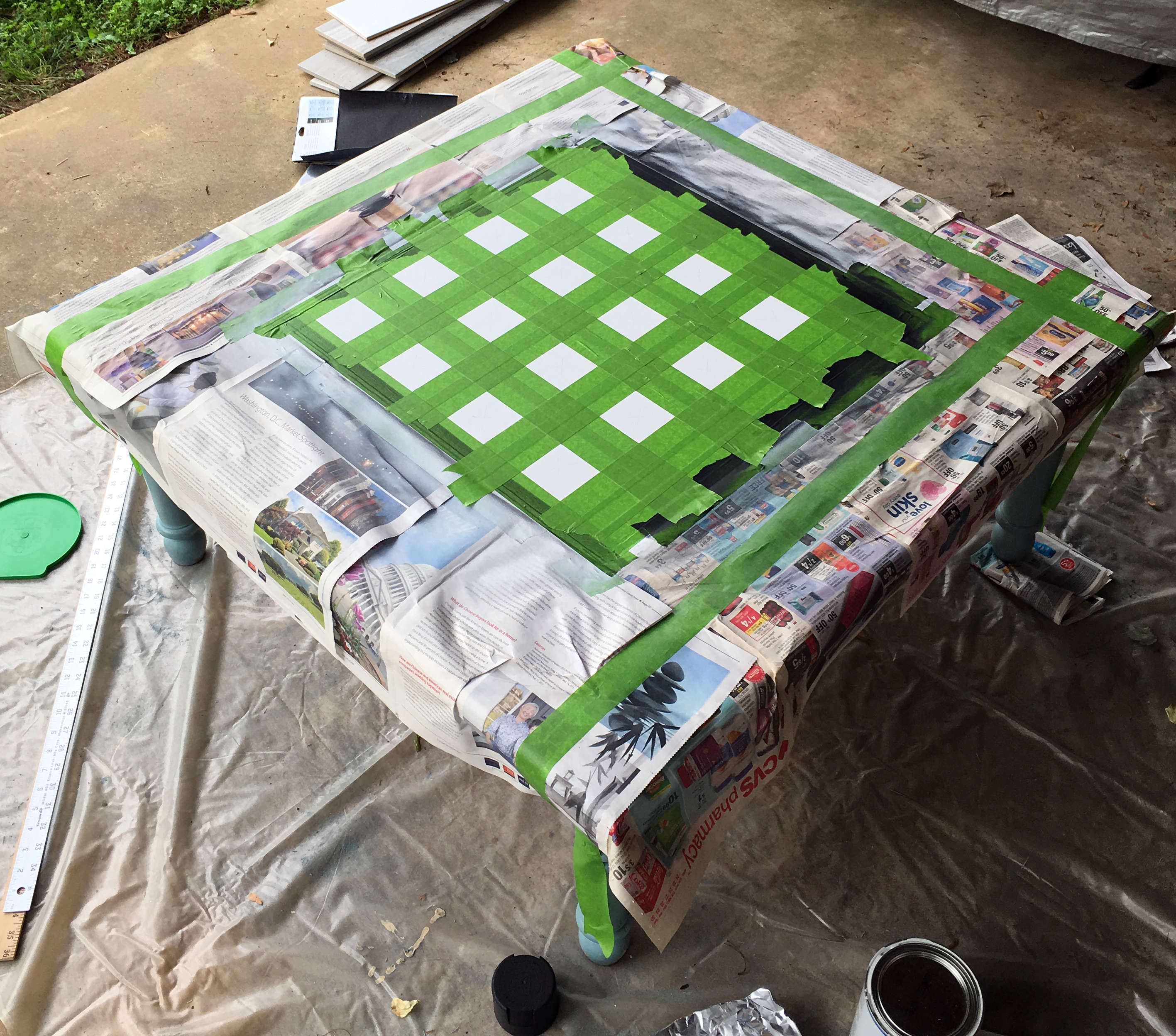 Painting the table with FrogTape and matte spray paint.
